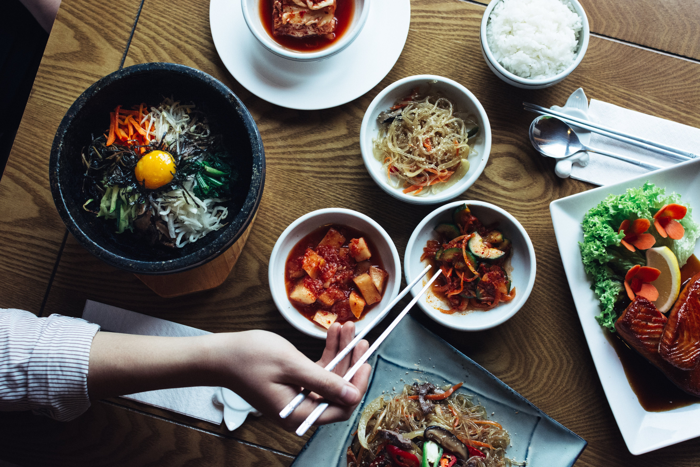 Woman eating Korean foods in the restaurant